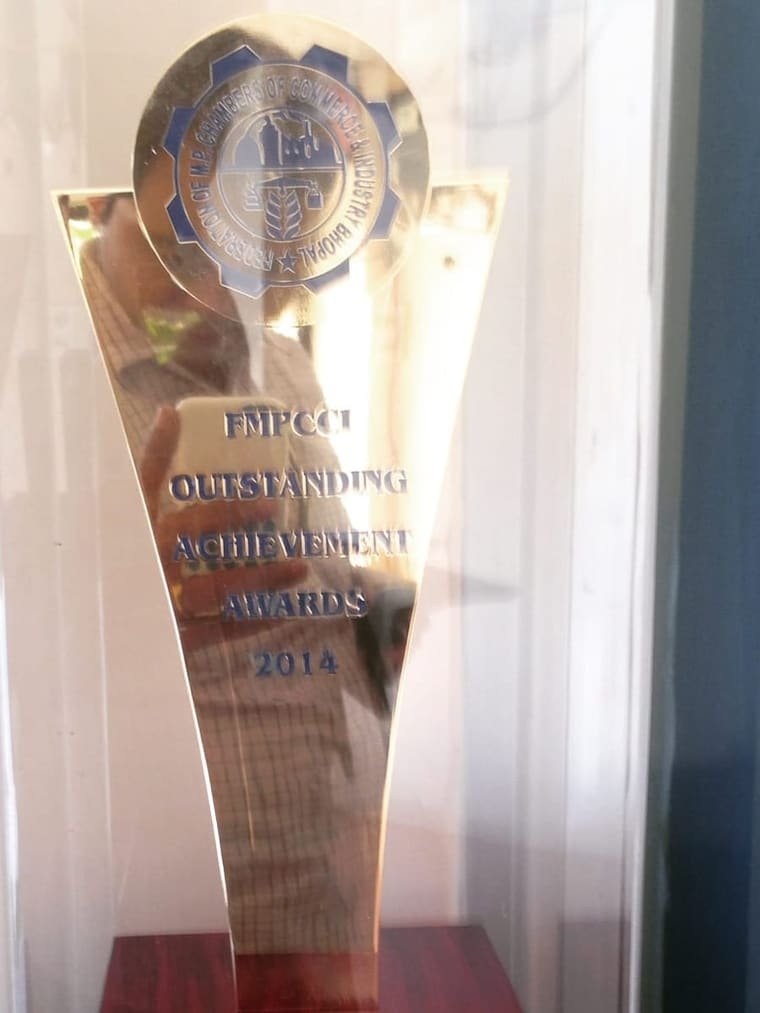 A metal trophy engraved FMPCCI Outstanding Achievement Awards 2014