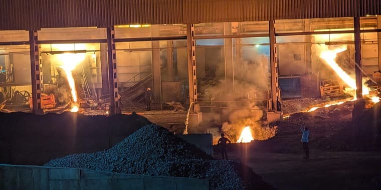 Three furnace bays running, molten alloy streaming from each